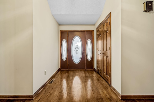 entrance foyer featuring dark wood-type flooring and a textured ceiling