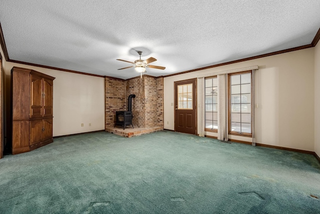 unfurnished living room featuring carpet floors, a wood stove, a textured ceiling, and crown molding