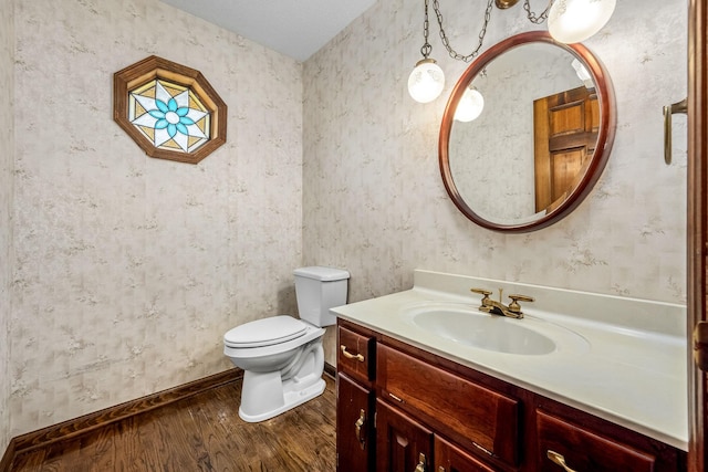 bathroom with vanity, hardwood / wood-style flooring, and toilet