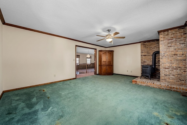 unfurnished living room featuring carpet, a textured ceiling, a wood stove, ceiling fan, and crown molding