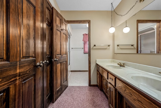 bathroom with vanity and a textured ceiling