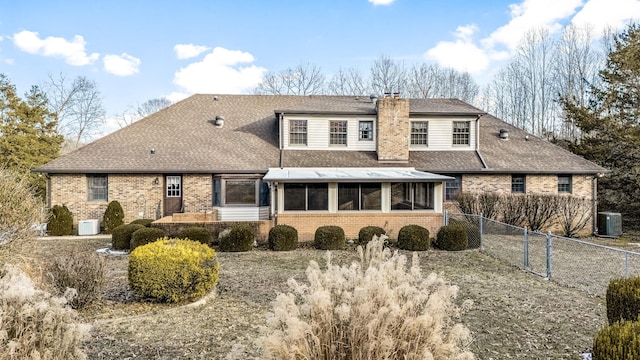 rear view of property with cooling unit and a sunroom