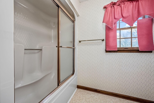 bathroom with shower / bath combination with glass door