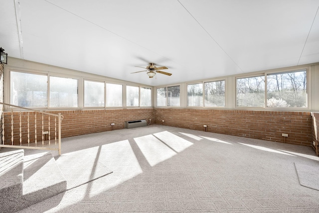 unfurnished sunroom featuring ceiling fan and lofted ceiling