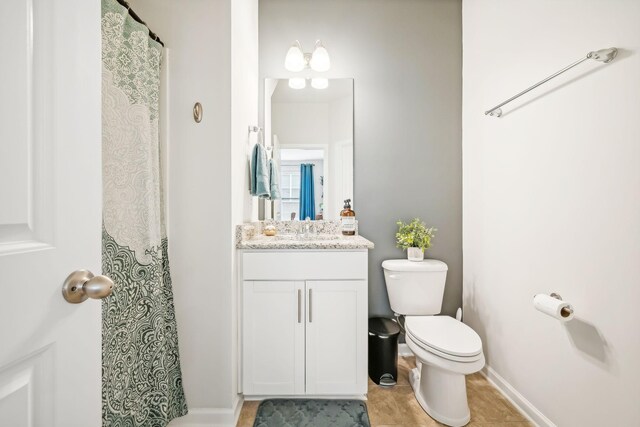 bathroom featuring vanity, toilet, and tile patterned floors