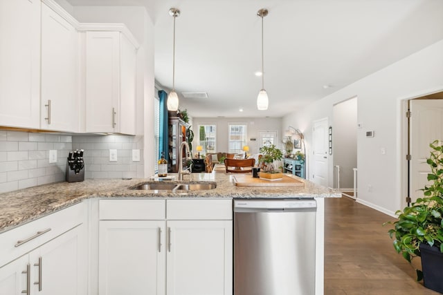 kitchen with light stone countertops, pendant lighting, dishwasher, white cabinetry, and sink