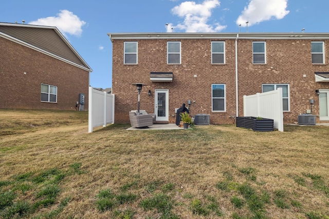 back of property with a patio, central AC, and a yard