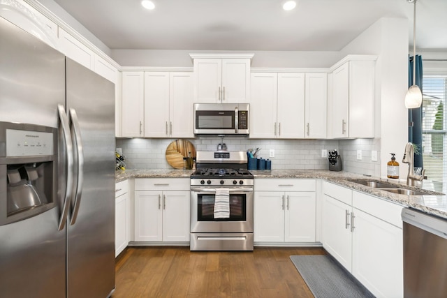 kitchen with sink, white cabinets, and stainless steel appliances