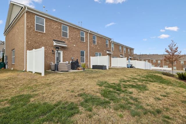 back of property featuring a lawn