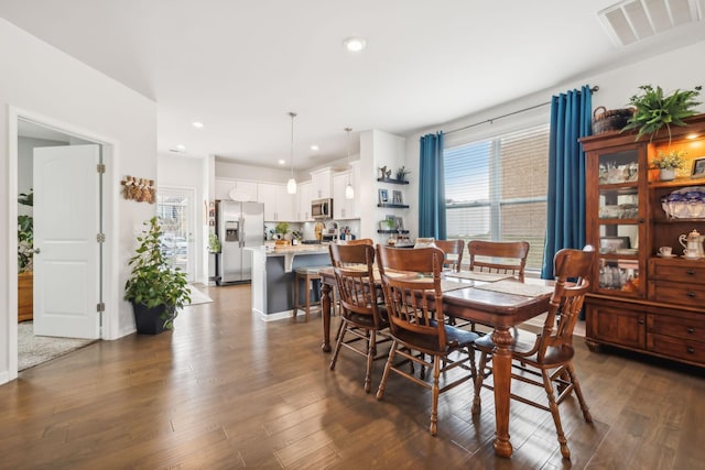 dining area with dark hardwood / wood-style floors