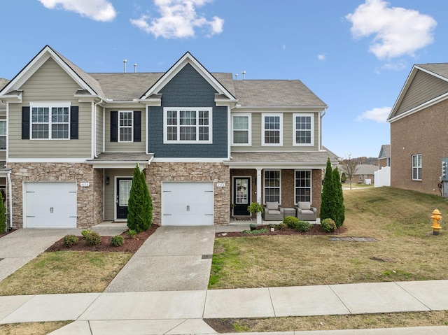 view of front of home with a front yard, a porch, and a garage