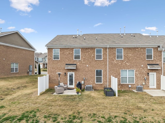 back of property featuring outdoor lounge area, a patio, central AC, and a yard