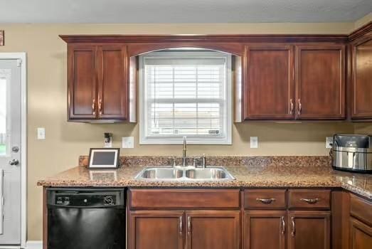 kitchen featuring sink, dishwasher, and light stone counters