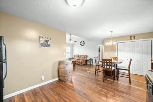 dining space featuring hardwood / wood-style flooring and ceiling fan