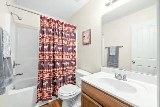 full bathroom with vanity, toilet, and shower / tub combo