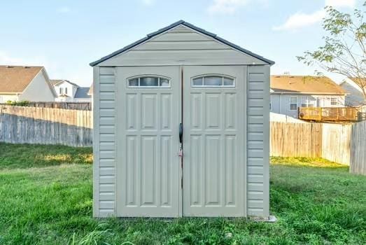 view of outbuilding featuring a lawn