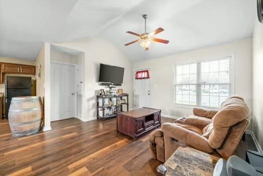 living room featuring lofted ceiling, dark hardwood / wood-style floors, and ceiling fan