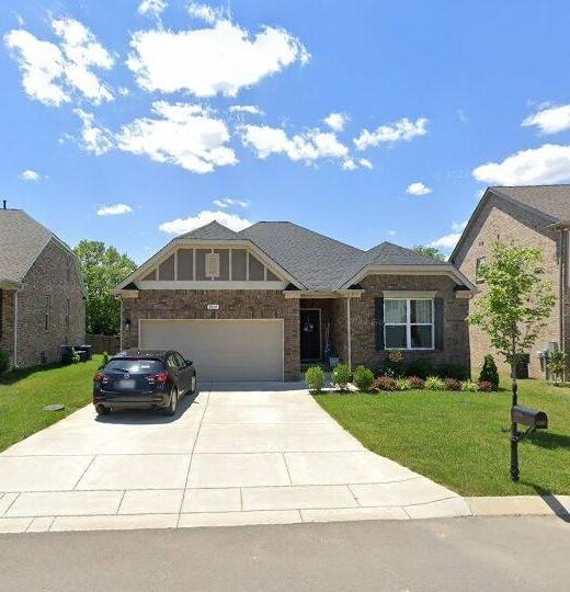 view of front of house featuring a garage and a front lawn