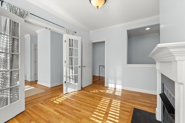 unfurnished living room featuring crown molding and wood-type flooring