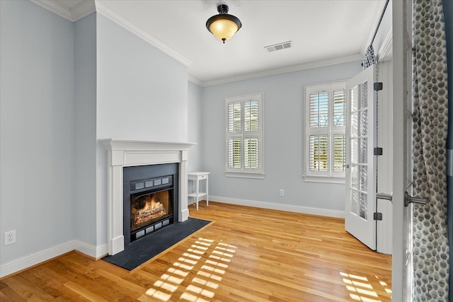 unfurnished living room featuring ornamental molding and light hardwood / wood-style floors