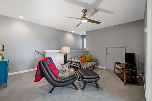 sitting room with ceiling fan and carpet flooring