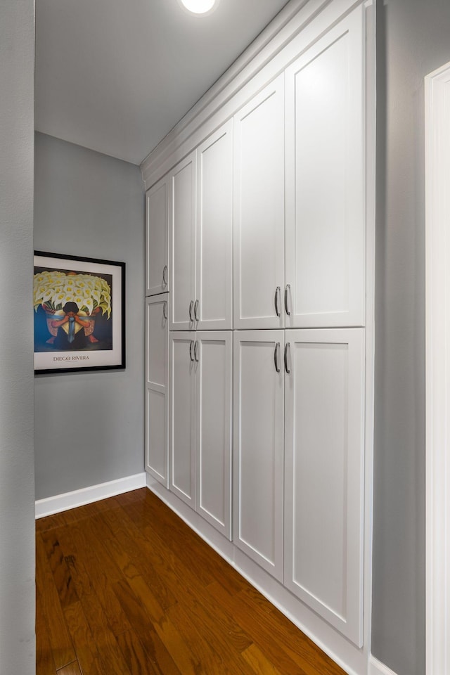 corridor featuring dark hardwood / wood-style flooring