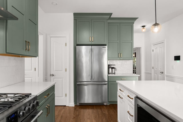 kitchen featuring beverage cooler, decorative light fixtures, decorative backsplash, green cabinets, and high end fridge