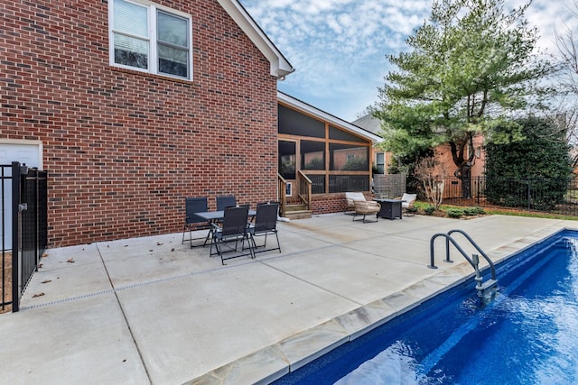 view of pool featuring a patio and a sunroom