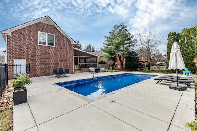 view of pool with a patio area and a sunroom