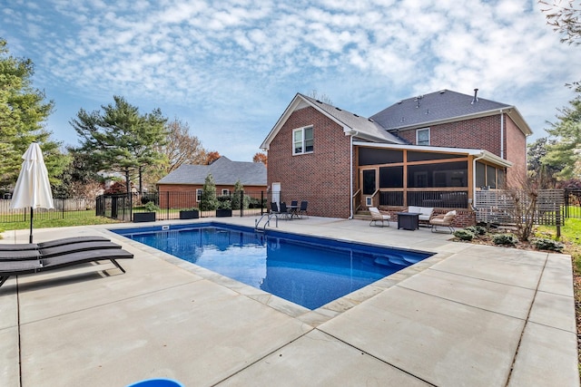 view of pool featuring a sunroom, a patio, and outdoor lounge area