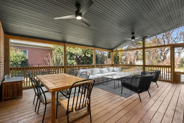 wooden terrace featuring ceiling fan and an outdoor living space