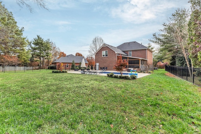 view of yard with a fenced in pool, a sunroom, and a patio