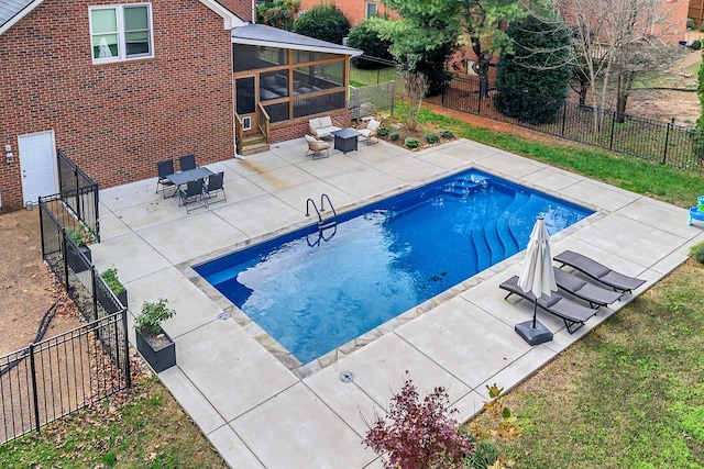 view of pool featuring a patio area and a sunroom