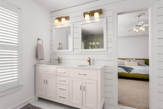 bathroom with ceiling fan, vanity, and wood walls