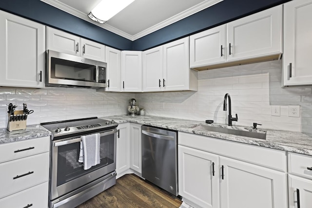 kitchen with stainless steel appliances, sink, and white cabinets