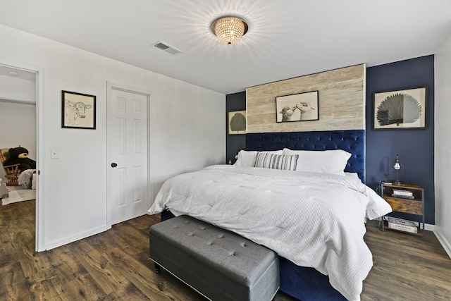 bedroom with dark hardwood / wood-style floors