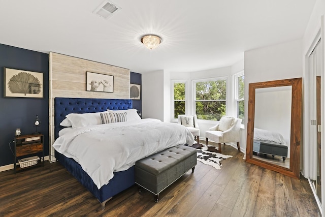 bedroom with dark hardwood / wood-style floors