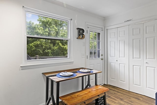 dining area with wood-type flooring and ornamental molding