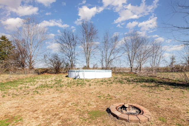 view of yard with a fire pit and a rural view