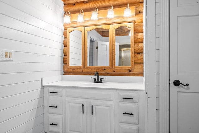 bathroom with vanity and wood walls