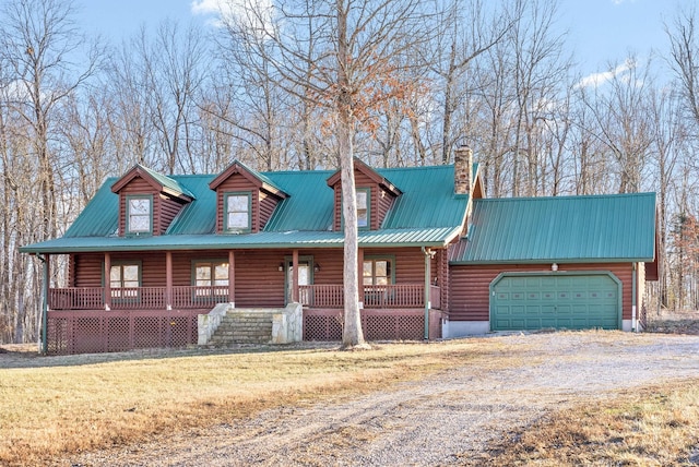 cabin featuring a garage and covered porch