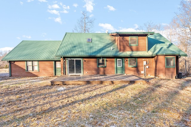 rear view of house with cooling unit and a deck