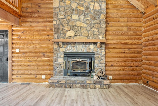 unfurnished living room with beam ceiling, rustic walls, hardwood / wood-style floors, and wooden ceiling