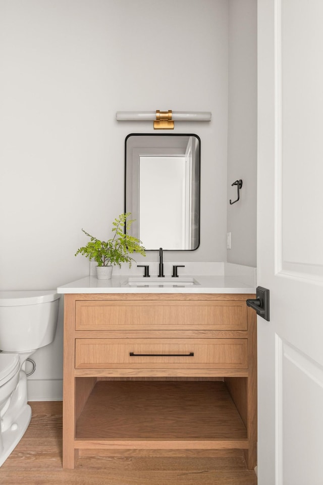 half bathroom featuring toilet and vanity