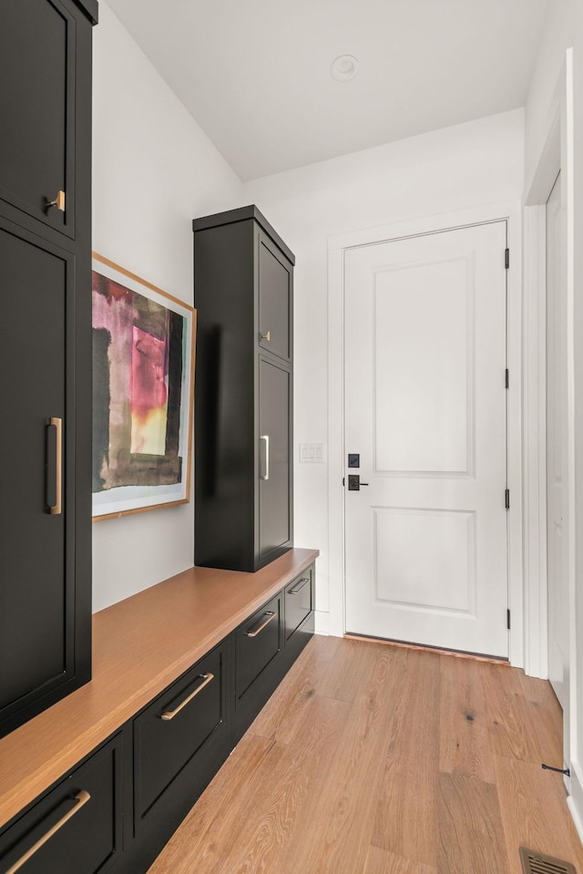 mudroom featuring light wood-style flooring and visible vents