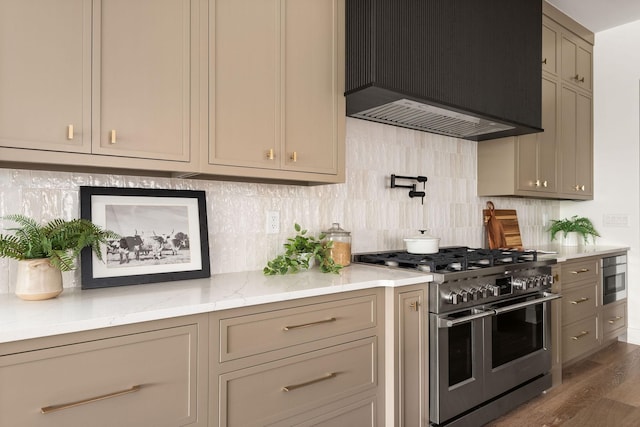 kitchen featuring premium range hood, stainless steel appliances, light stone counters, and backsplash