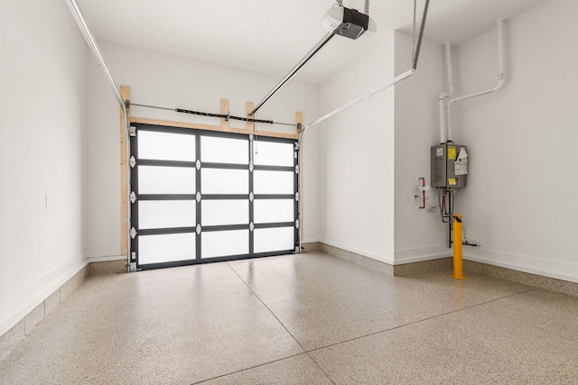 garage featuring baseboards, a garage door opener, and water heater