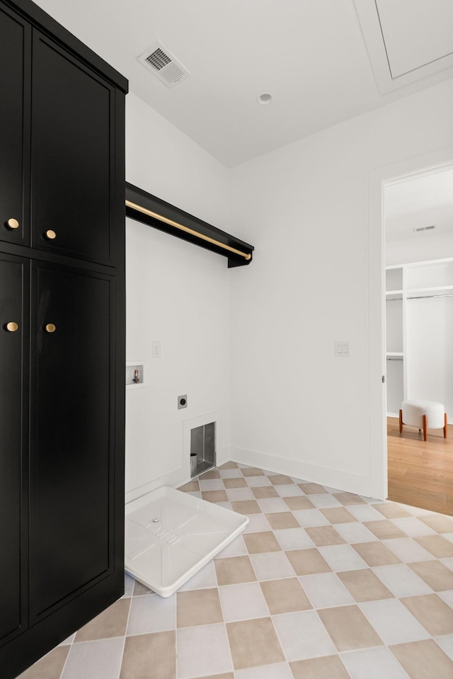 laundry area with visible vents, baseboards, washer hookup, cabinet space, and electric dryer hookup