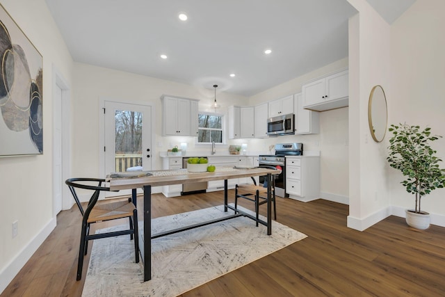 kitchen with white cabinetry, dark hardwood / wood-style floors, and appliances with stainless steel finishes