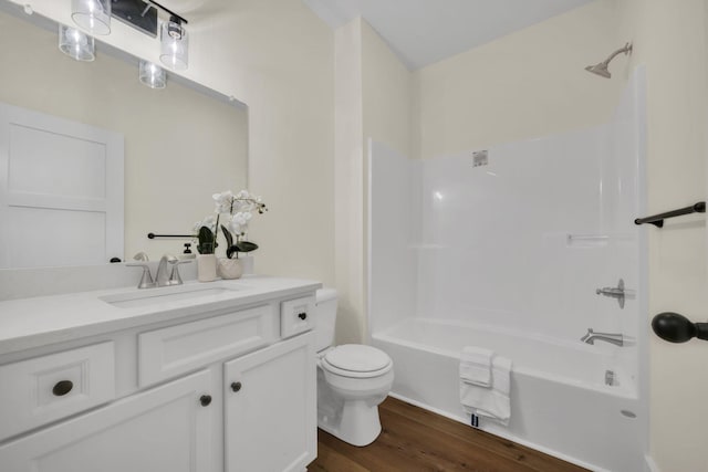 full bathroom with shower / washtub combination, toilet, hardwood / wood-style floors, and vanity